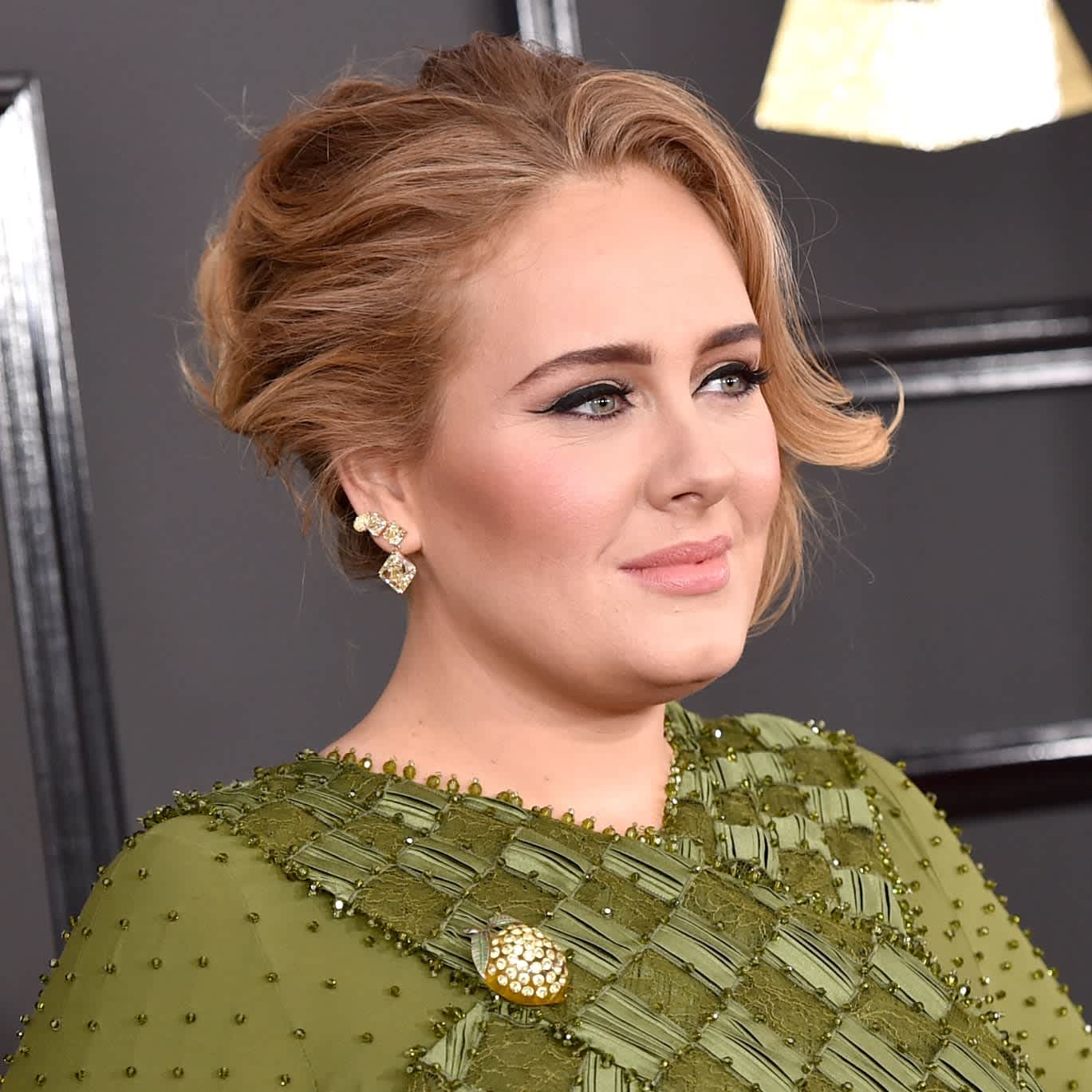We're obsessed with Adele's new trench coat and gold earrings