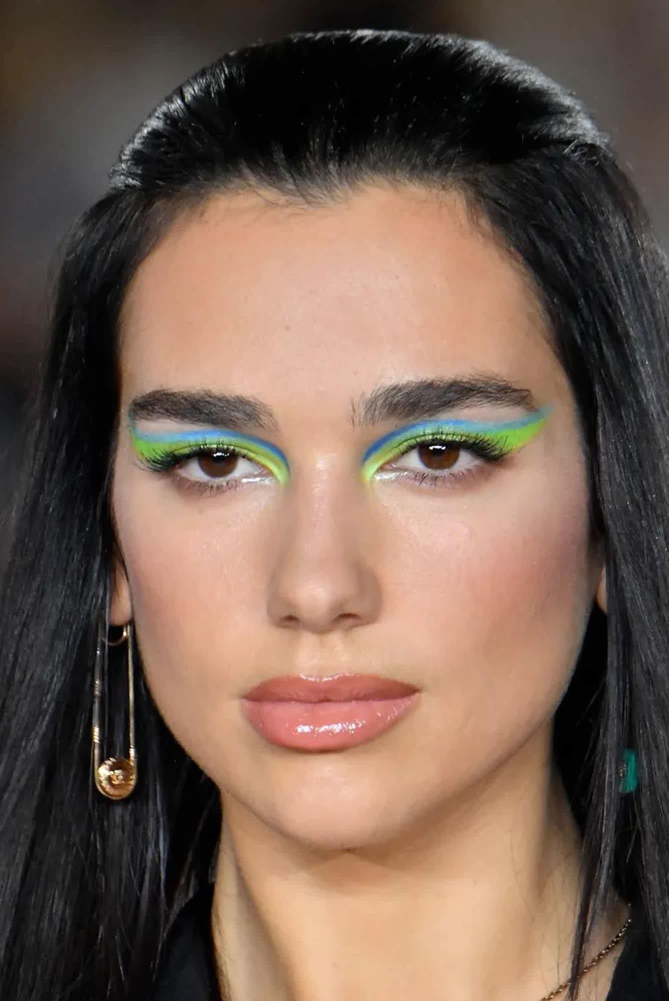 Dua Lipa wearing a acid green and pastel blue eye makeup rainbow on the SS21 Versace Runway