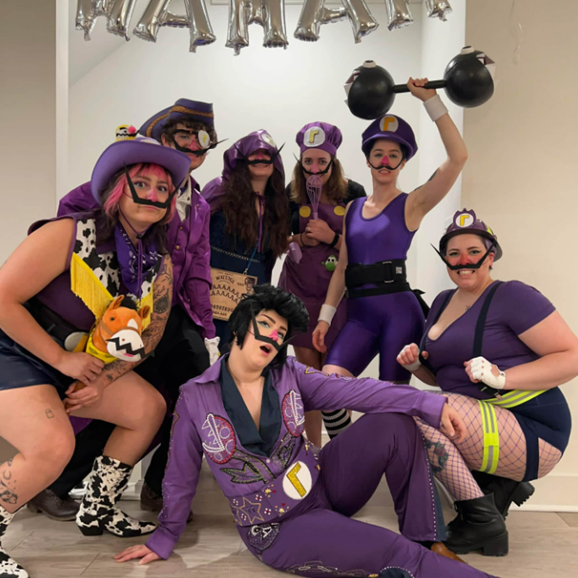 A photo from the Waluigi bachelorette party of cowboy Waluigi, pirate Waluigi, cult Waluigi, Elvis Waluigi, chef Waluigi, strongman Waluigi and sexy firefighter Waluigi.