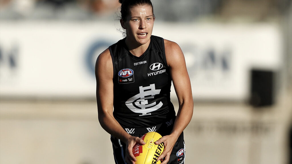 Jess Good AFLW player holding football